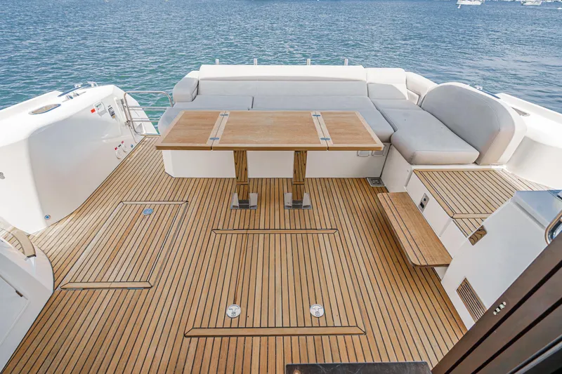 Slide: The Image of 2019 Prestige 520S yacht deck with wooden flooring and seating area. - 14