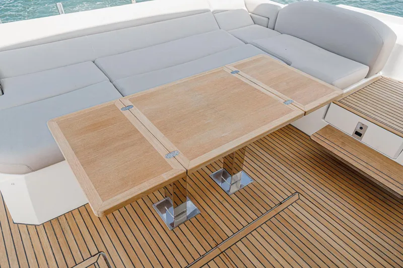 Slide: The Image of Luxurious 2019 Prestige 520S yacht deck with wooden table and cushioned seating. - 15