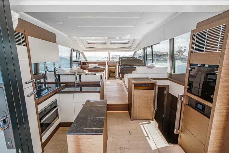 Slide: The Image of Luxurious interior of a 2019 Prestige 520S yacht, featuring modern kitchen and spacious seating. - 20