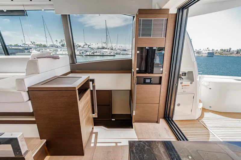 Slide: The Image of Luxurious interior of 2019 Prestige 520S yacht with modern wood finishes and marina view. - 24