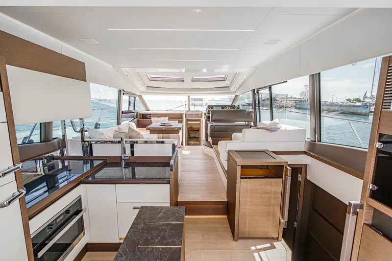 Slide: The Image of Luxurious interior of 2019 Prestige 520S yacht with modern kitchen and seating area. - 25