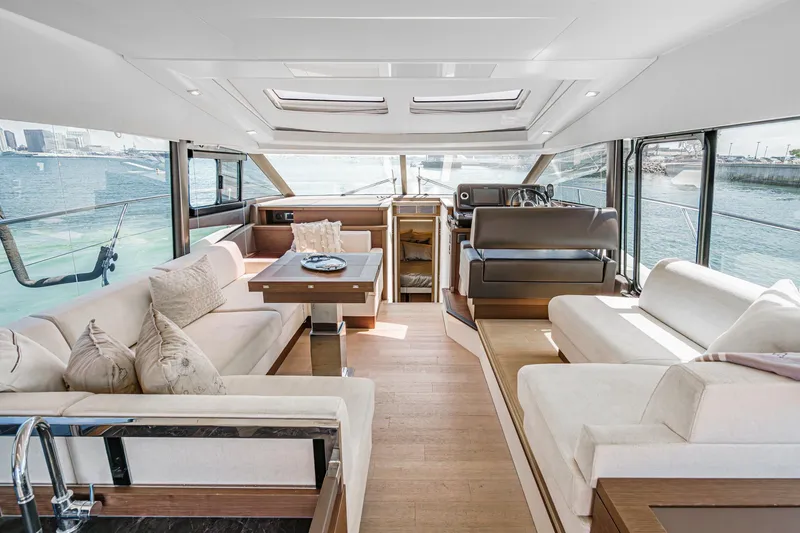 Slide: The Image of Luxurious interior of 2019 Prestige 520S yacht with elegant seating and panoramic windows. - 26
