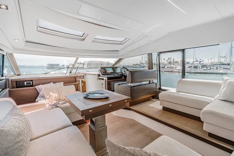Slide: The Image of Luxurious interior of 2019 Prestige 520S yacht with elegant seating and panoramic windows. - 28