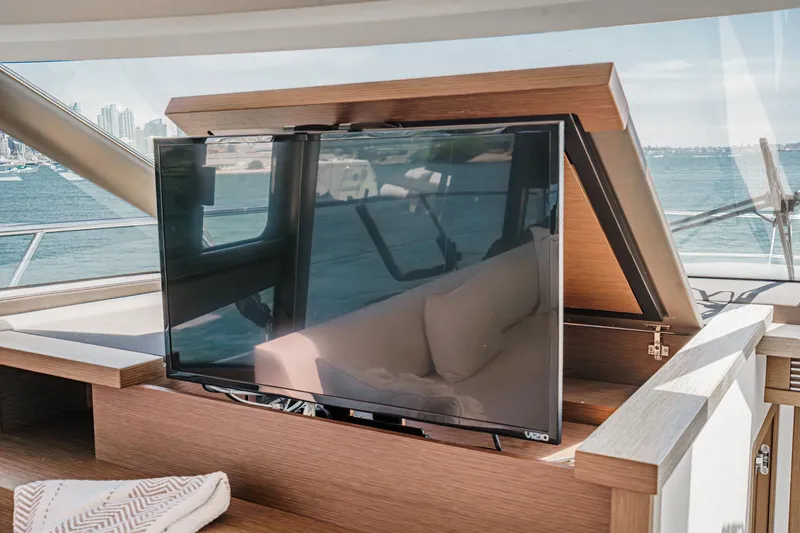 Slide: The Image of Flat-screen TV on 2019 Prestige 520S yacht with ocean view in background. - 30
