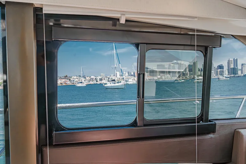 Slide: The Image of View from 2019 Prestige 520S yacht window, showcasing city skyline and marina. - 31