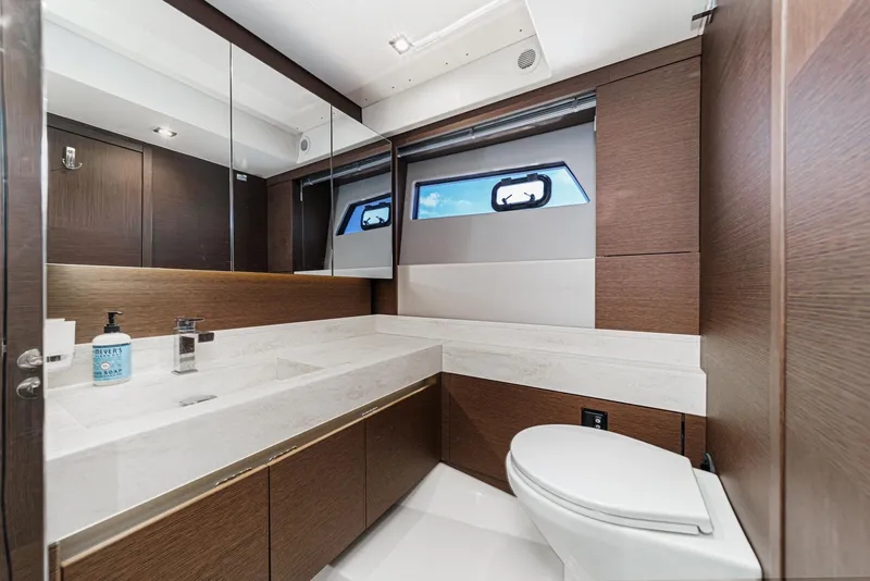 Slide: The Image of Luxurious bathroom in 2019 Prestige 520S yacht with modern fixtures and elegant wood accents. - 40