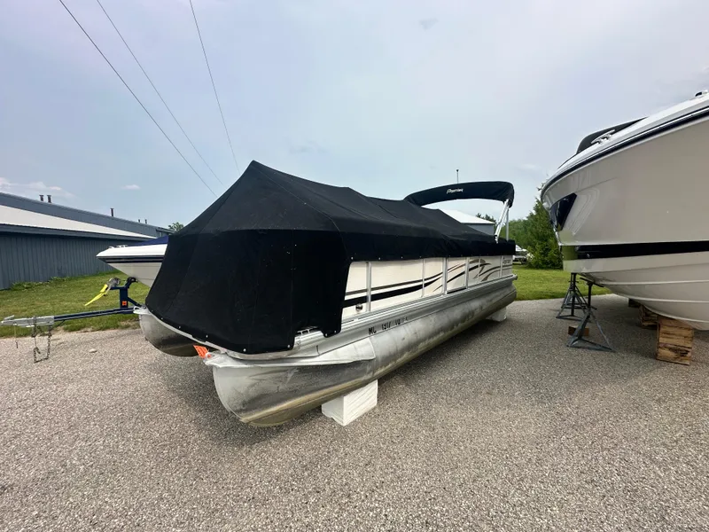 Slide: The Image of 2008 Premier 240 SunSpree pontoon boat with black cover, parked on gravel. - 10