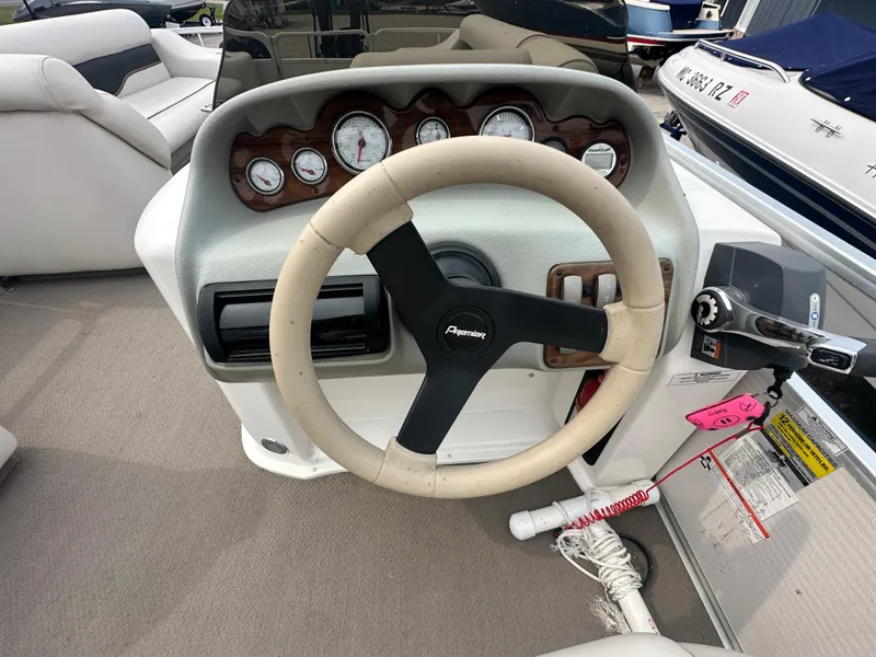 Slide: The Image of Steering console of a 2008 Premier 240 SunSpree boat with gauges and controls. - 4