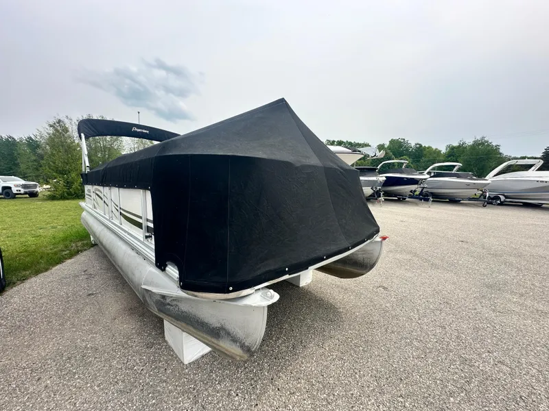 Slide: The Image of 2008 Premier 240 SunSpree pontoon boat with black cover in a parking area. - 9