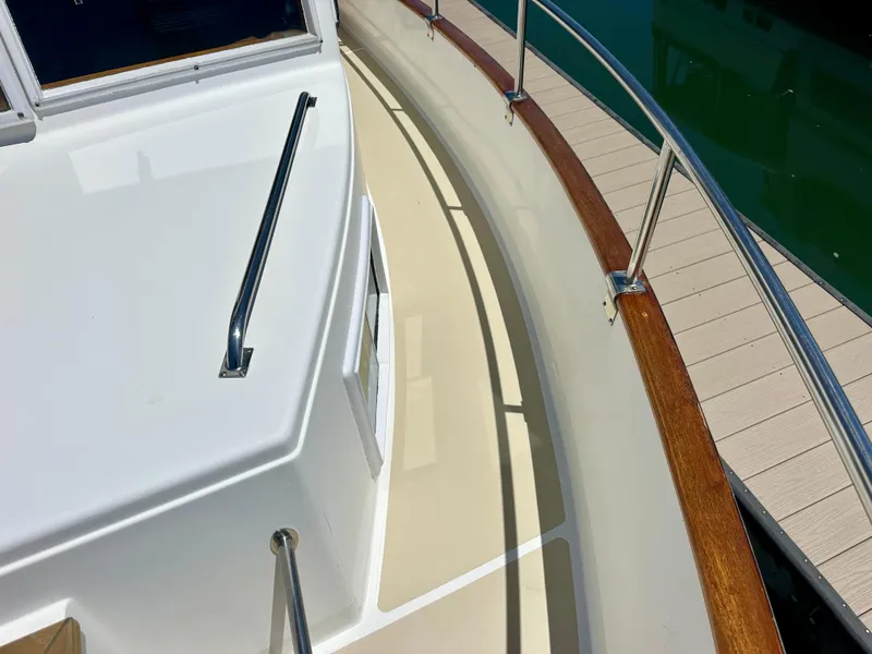 Slide: The Image of Deck view of a 1994 Grand Banks 42 Classic yacht with wooden railings. - 13