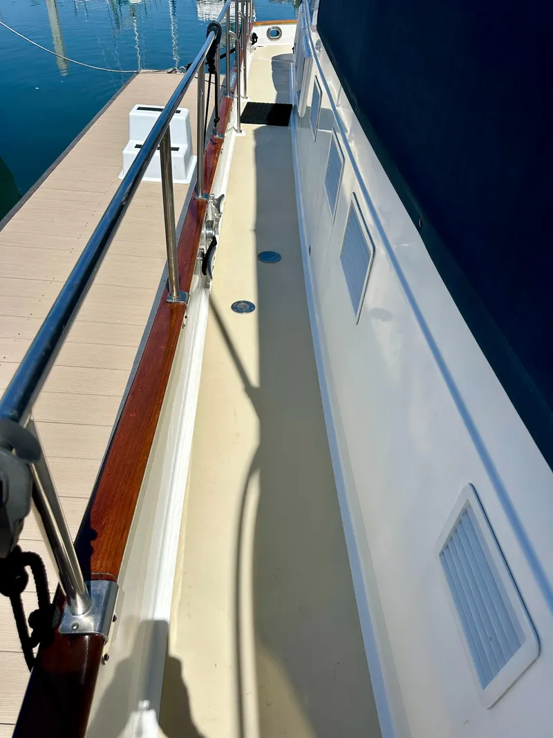 Slide: The Image of Side deck of a 1994 Grand Banks 42 Classic yacht with wooden railings. - 16