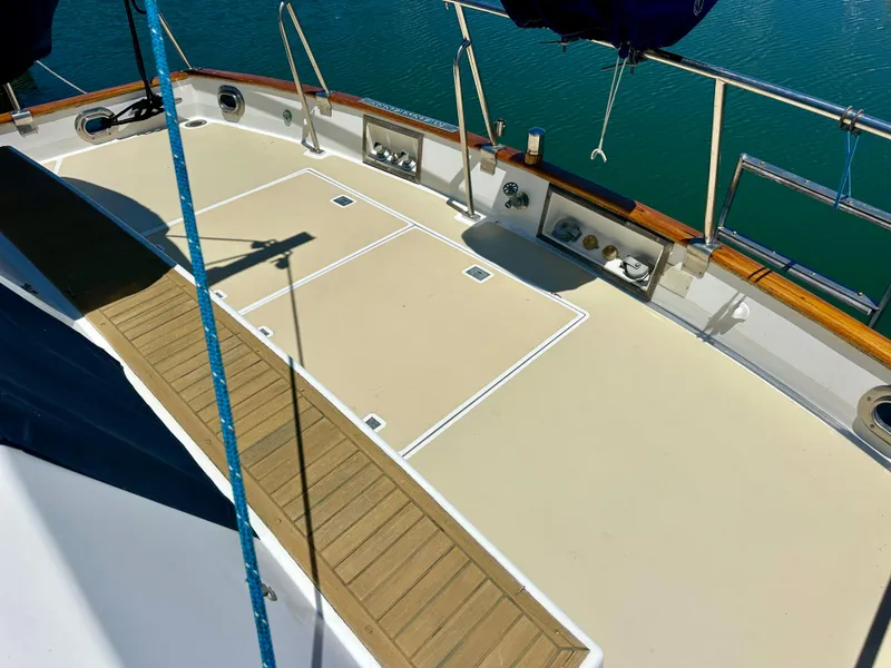 Slide: The Image of Deck of 1994 Grand Banks 42 Classic yacht with wooden accents and railing. - 18