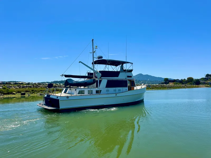 Slide: The Image of 1994 Grand Banks 42 Classic yacht cruising on a sunny day in calm waters. - 2