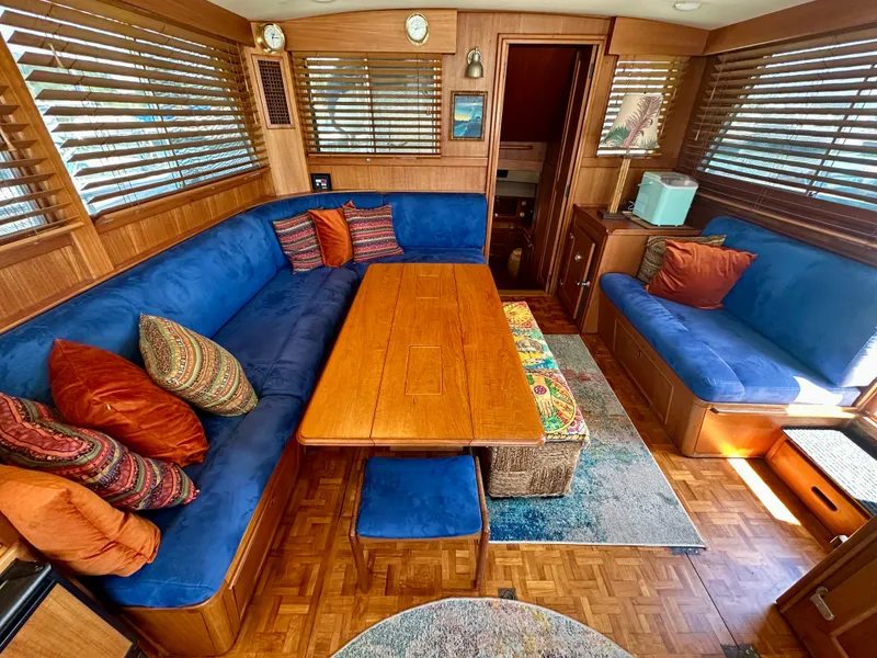Slide: The Image of Interior of 1994 Grand Banks 42 Classic yacht with blue seating and wooden table. - 25