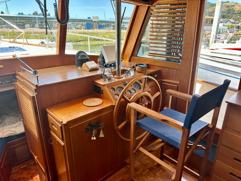 Slide: The Image of Interior helm of 1994 Grand Banks 42 Classic yacht with wooden steering wheel and chair. - 27