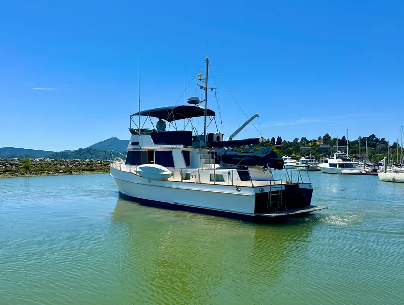 Slide: The Image of 1994 Grand Banks 42 Classic yacht on calm water under clear blue sky. - 3