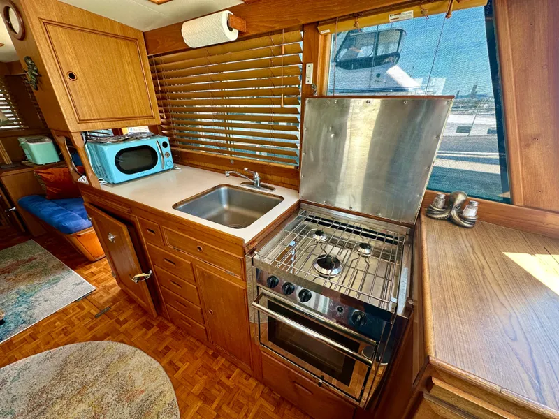 Slide: The Image of 1994 Grand Banks 42 Classic yacht kitchen with stove, sink, and microwave. - 30