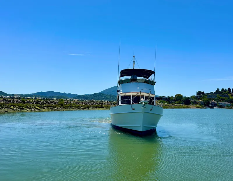 Slide: The Image of 1994 Grand Banks 42 Classic yacht on calm water under clear blue sky. - 4