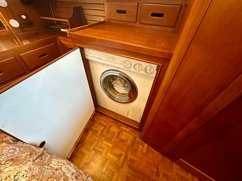 Slide: The Image of Laundry area with a washing machine in a 1994 Grand Banks 42 Classic yacht interior. - 46