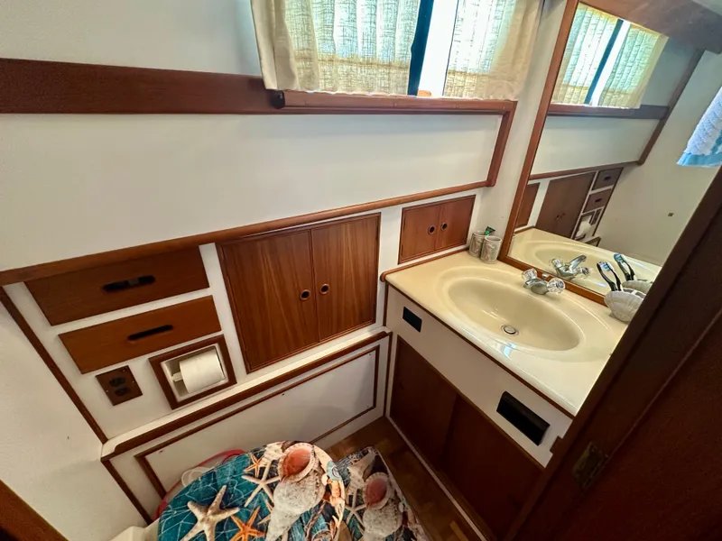 Slide: The Image of Bathroom interior of 1994 Grand Banks 42 Classic yacht, featuring wood accents and a sink. - 48