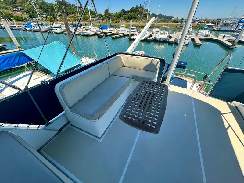 Slide: The Image of Flybridge seating on 1994 Grand Banks 42 Classic yacht, docked in a marina. - 8