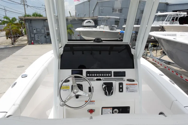 Slide: The Image of 2025 Sea Fox 248 Commander boat dashboard with steering wheel and control panel. - 10