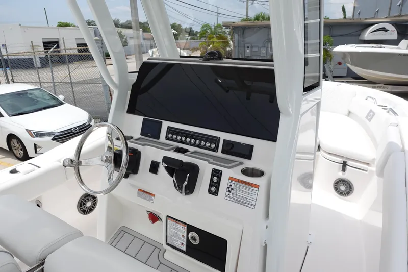 Slide: The Image of 2025 Sea Fox 248 Commander boat dashboard with steering wheel and control panel. - 11