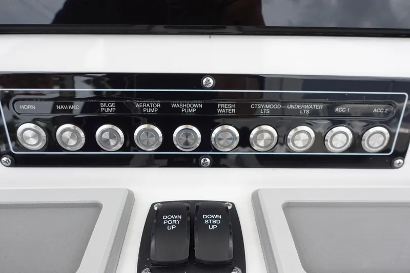 Slide: The Image of Control panel of 2025 Sea Fox 248 Commander boat with labeled switches. - 13