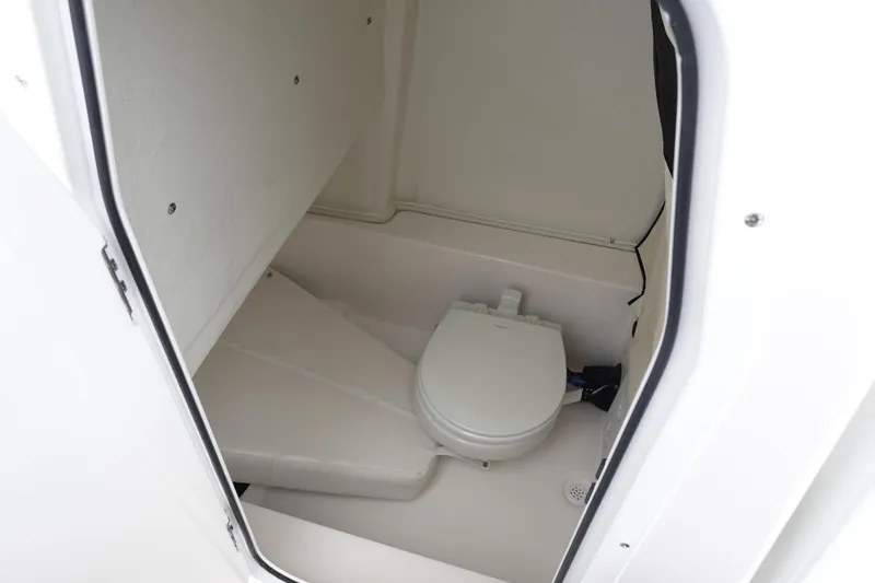 Slide: The Image of Interior of 2025 Sea Fox 248 Commander boat, featuring a compact marine toilet. - 17