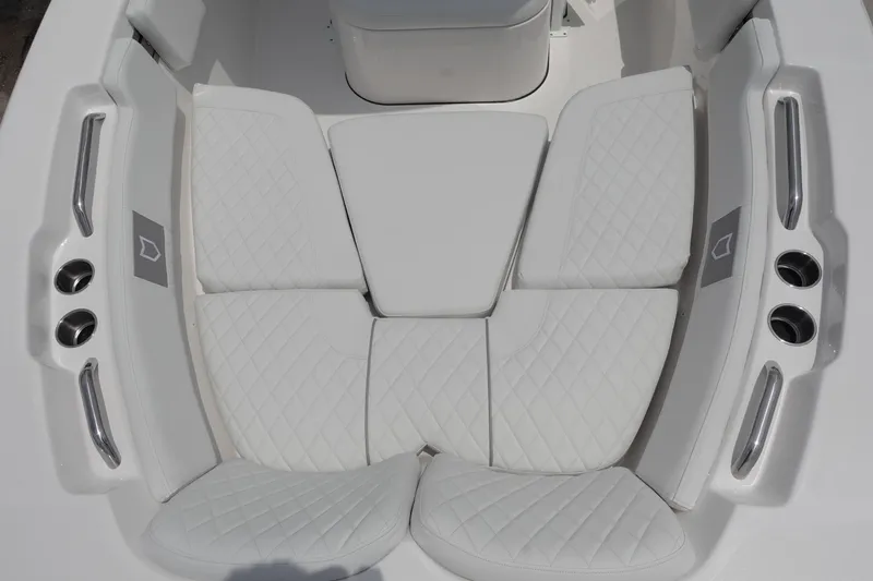 Slide: The Image of 2025 Sea Fox 248 Commander boat seating with white quilted cushions and cup holders. - 22