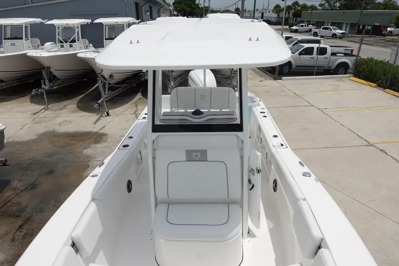 Slide: The Image of 2025 Sea Fox 248 Commander boat, white exterior, docked in a marina with other boats. - 23