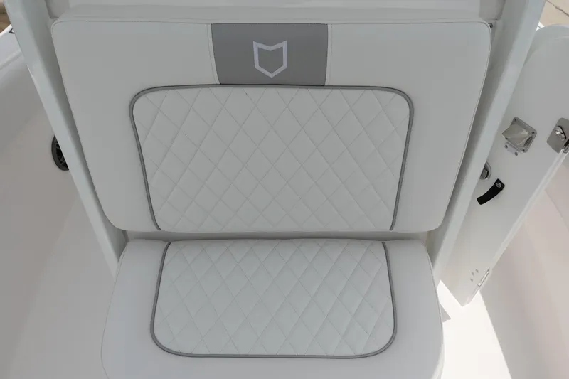 Slide: The Image of 2025 Sea Fox 248 Commander boat seat with quilted white upholstery and gray accents. - 24