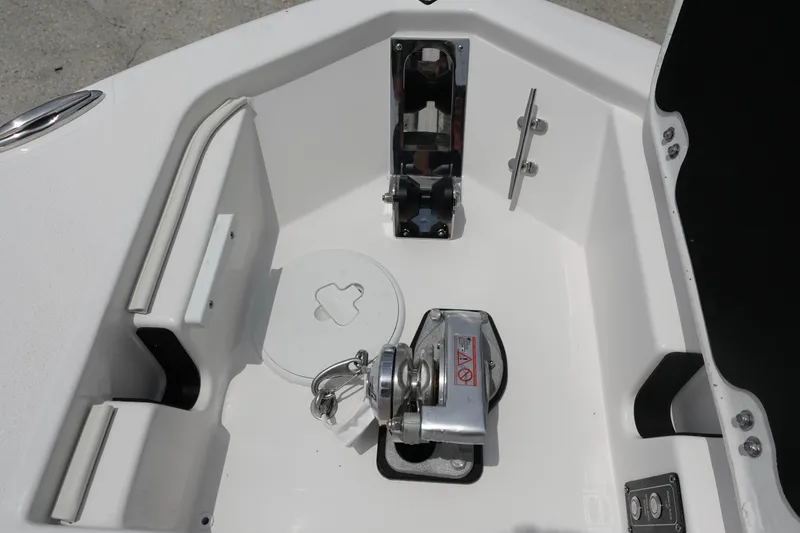 Slide: The Image of Anchor compartment of 2025 Sea Fox 248 Commander boat, featuring a winch and storage area. - 25