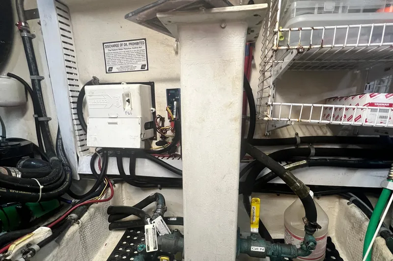 Slide: The Image of Engine room of 2006 Great Harbour N37 with wiring, pipes, and storage shelves. - 10