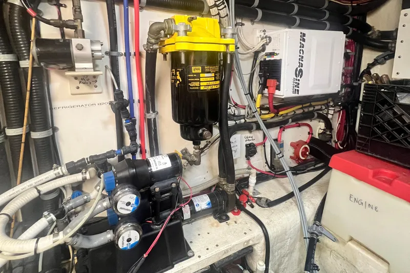 Slide: The Image of Engine room of a 2006 Great Harbour N37 boat with various mechanical components. - 12