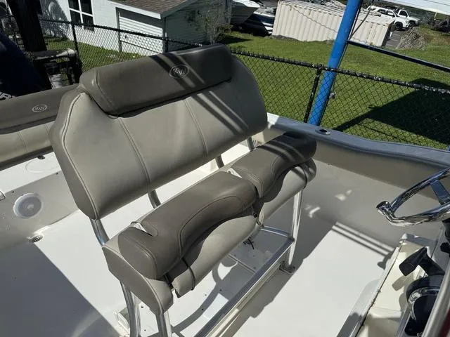 Slide: The Image of 2022 Key West 239FS boat interior with cushioned seating and steering wheel. - 10