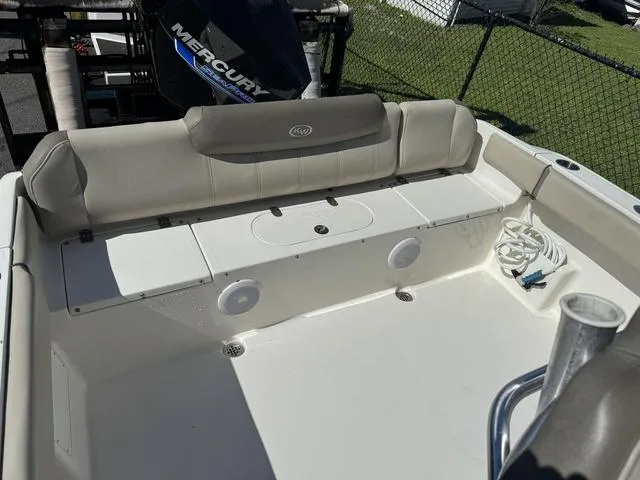 Slide: The Image of 2022 Key West 239FS boat interior with seating and Mercury engine in background. - 12