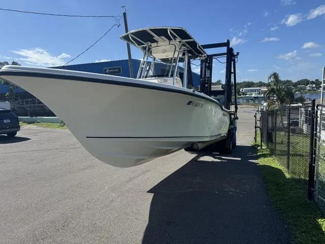 Slide: The Image of 2022 Key West 239FS boat on trailer, parked outdoors under clear blue sky. - 3