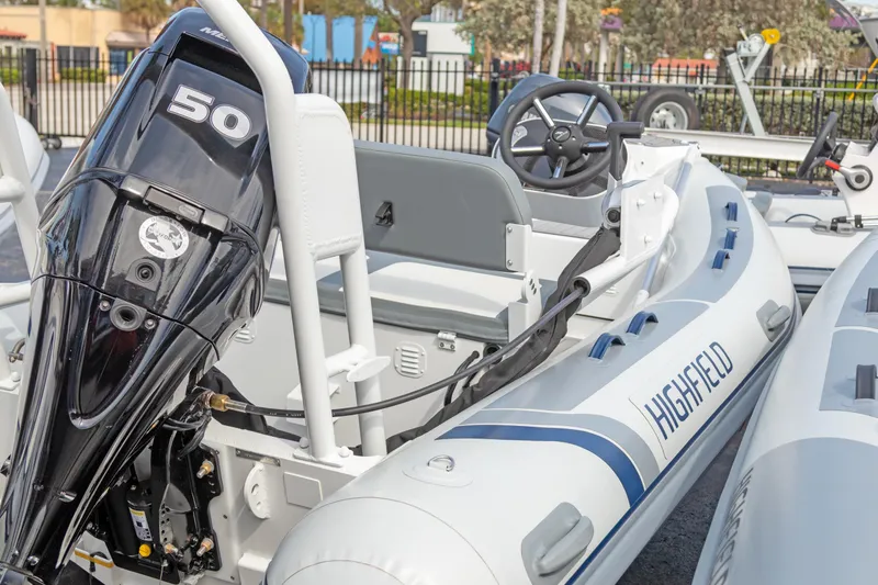 Slide: The Image of 2025 Highfield Classic 400 boat with 50 HP engine, featuring sleek design and modern steering. - 5