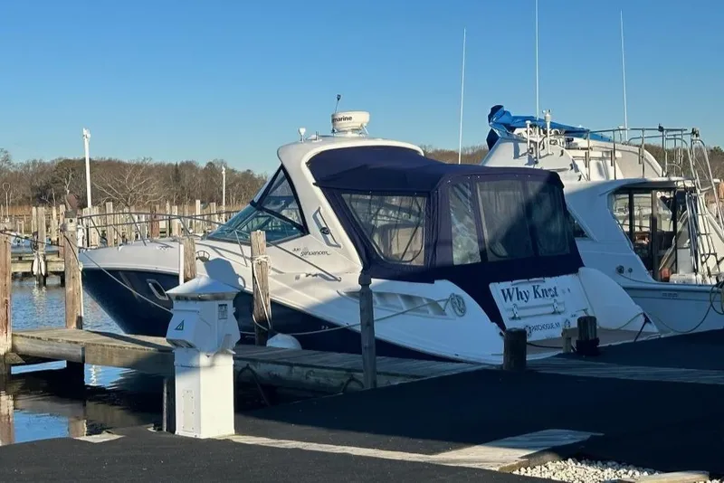 The Image of 2008 Sea Ray 330 Sundancer docked at marina under clear blue sky. - 0
