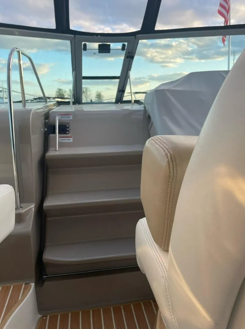 Slide: The Image of 2008 Sea Ray 330 Sundancer interior with steps and seating, featuring a scenic view. - 11