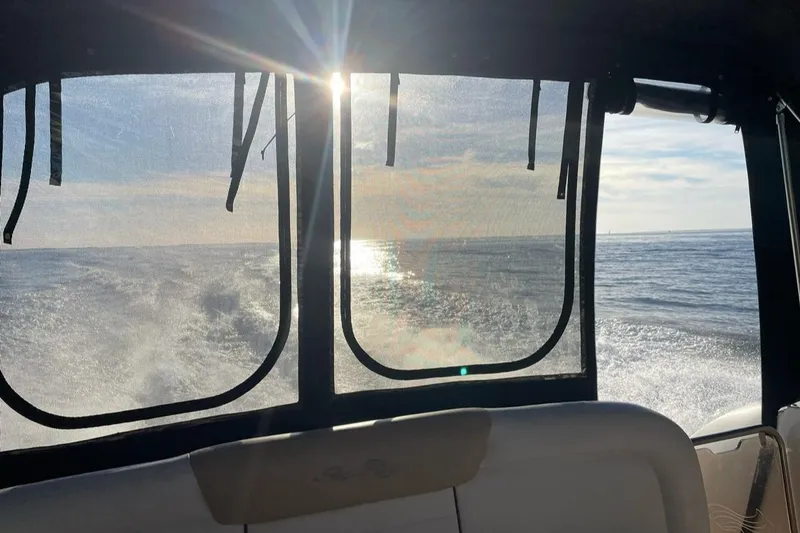 Slide: The Image of Interior view from a 2008 Sea Ray 330 Sundancer boat, overlooking the ocean at sunset. - 12