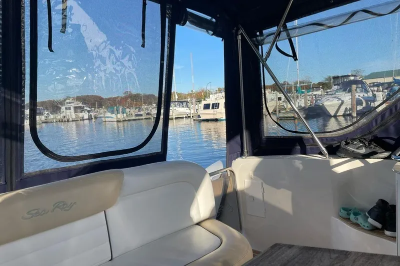 Slide: The Image of Interior view of 2008 Sea Ray 330 Sundancer at marina, showcasing seating and windows. - 13