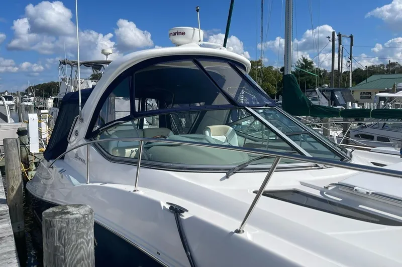 Slide: The Image of 2008 Sea Ray 330 Sundancer docked at marina under blue sky. - 2