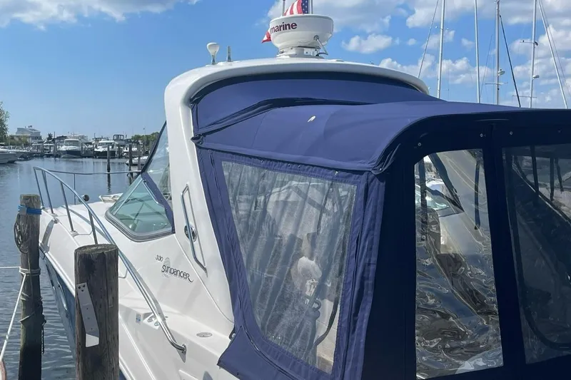 Slide: The Image of 2008 Sea Ray 330 Sundancer docked with blue canopy under clear sky. - 3