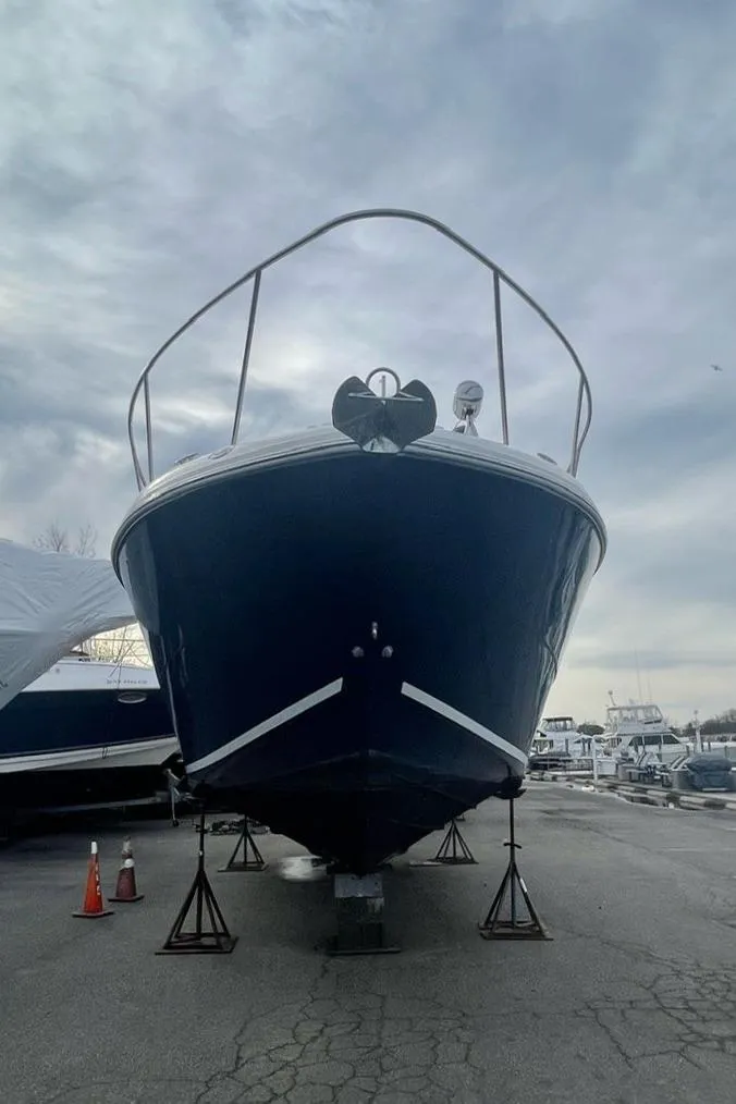 Slide: The Image of 2008 Sea Ray 330 Sundancer boat on stands, cloudy sky background. - 5