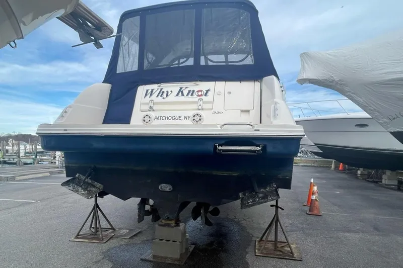 Slide: The Image of 2008 Sea Ray 330 Sundancer boat on stands, rear view, marina setting. - 9