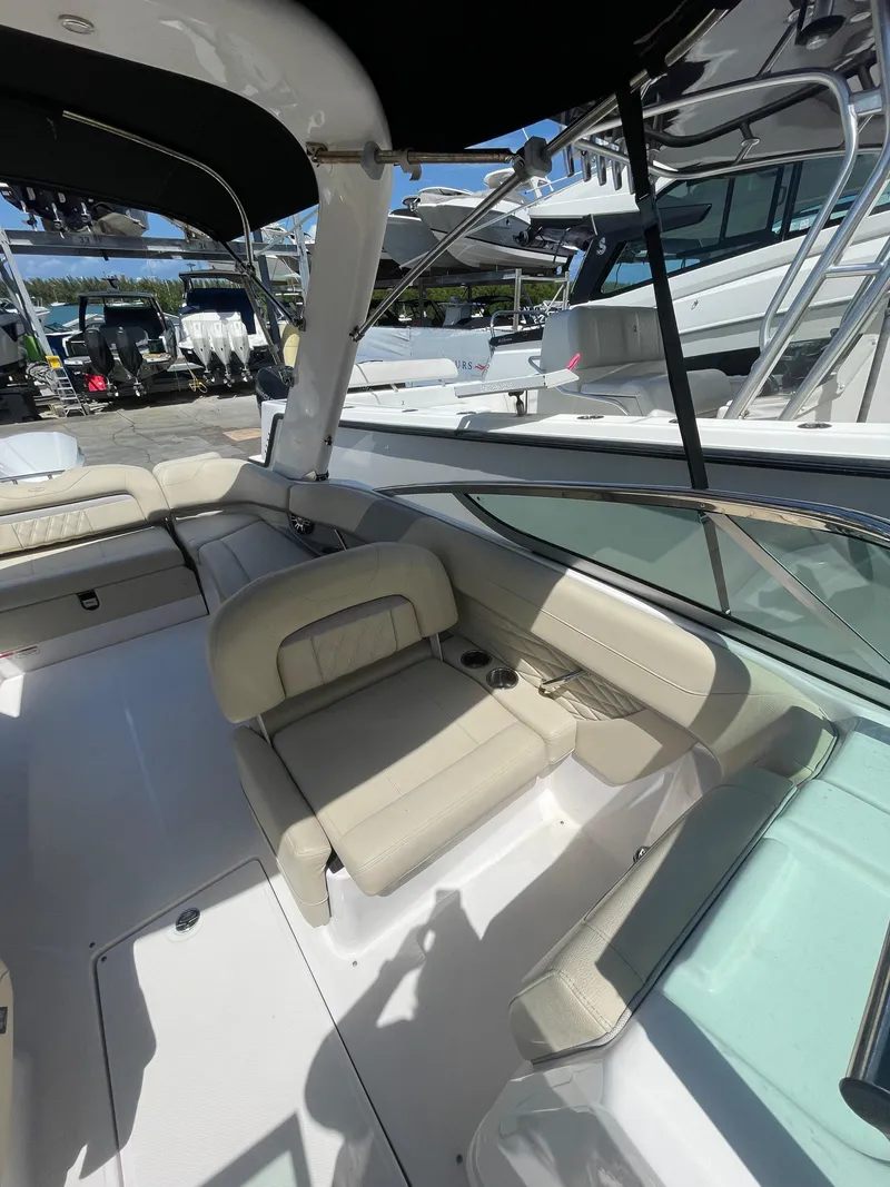 Slide: The Image of 2021 Regal 260BX boat interior with beige seating and sleek design. - 7