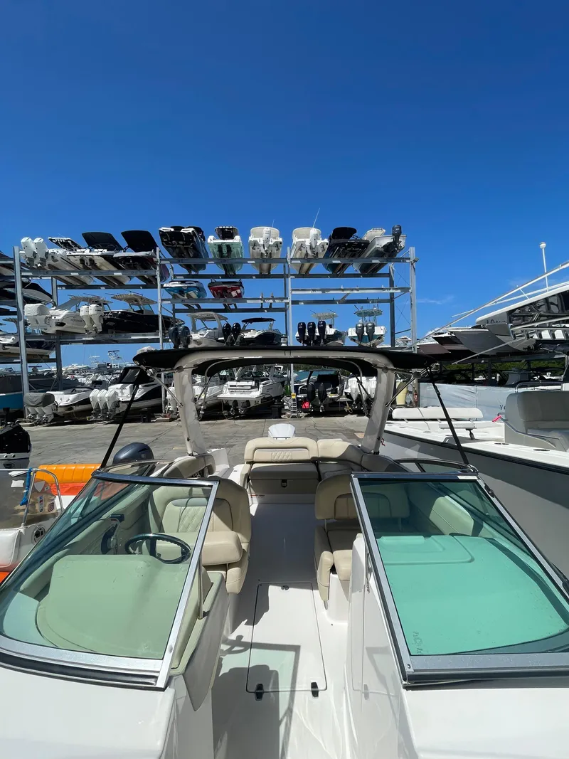 Slide: The Image of 2021 Regal 260BX boat docked with clear blue sky background. - 9