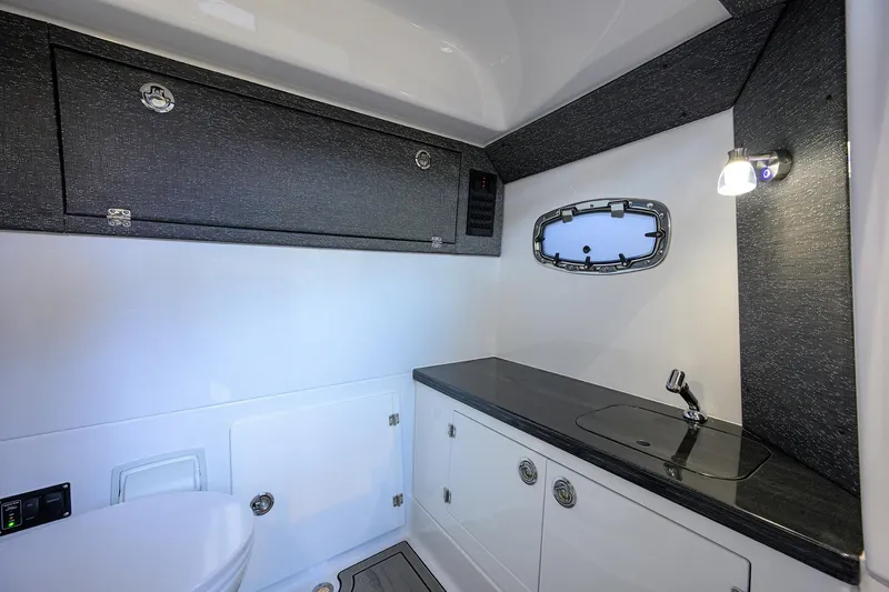 Slide: The Image of Luxurious bathroom interior of 2026 Monterey Elite 30 OB boat with modern fixtures. - 13